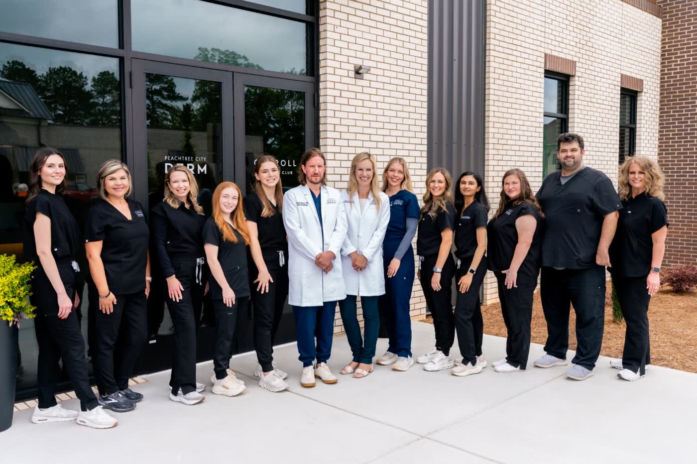 The Peachtree City Dermatology team outside the office entrance